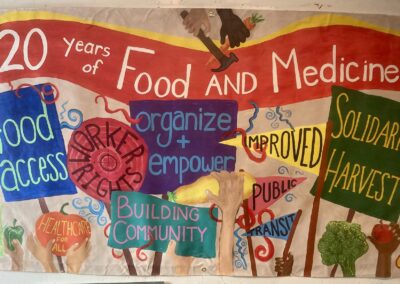20 Years of Food and Medicine banner with signs and foods