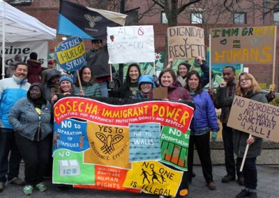 Rally goers hold colorfull banner for immigrant power