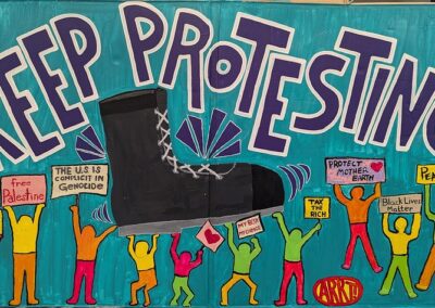 Keep Protesting in big letters is over a black boot that is being pushed off the backs of protestors with signs