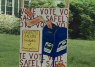 Yard sign encouraging voting has image of a blue postal drop box