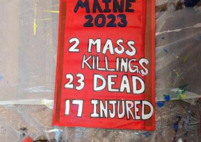 Protest sign text reads Maine 2023, mass killings 2, 23 dead, 17 injured