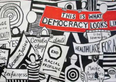 a black and white banner with slogans of racial and social justice with a banner in red - this is what democracy looks like