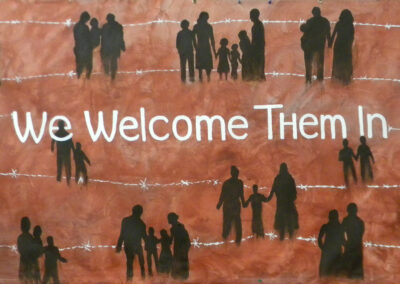 silhouettes of families and barbed wire with the words we welcome them in white.